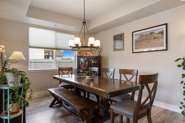 5901 W Ruby St, Pasco, WA 99301 - dining area featuring a chandelier, baseboards, wood finished floors, and a raised ceiling