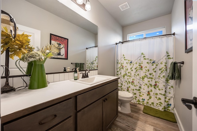 5901 W Ruby St, Pasco, WA 99301 - full bathroom featuring wood finished floors, toilet, vanity, and a shower with curtain