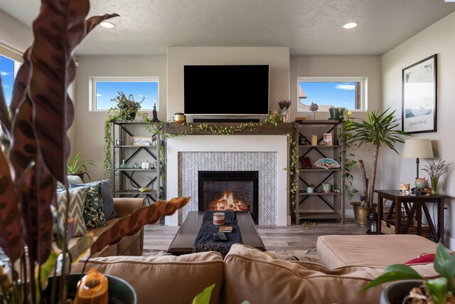 5901 W Ruby St, Pasco, WA 99301 - living room featuring a tile fireplace, wood finished floors, recessed lighting, and a textured ceiling