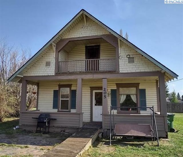 205 E 2nd St, Spangle, WA 99031 - bungalow-style home featuring a balcony, a porch, and fence