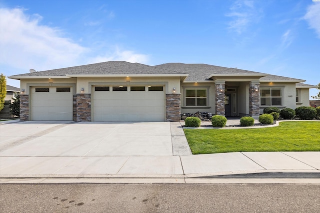 prairie-style home featuring a garage and a front yard