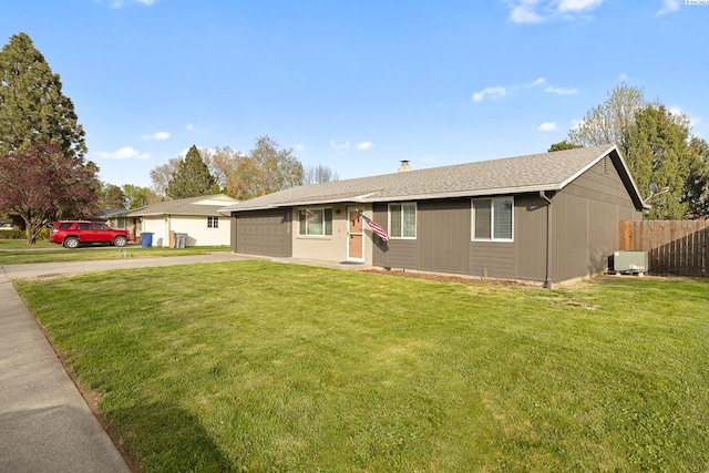 2128 Shasta Ave, Richland, WA 99354 - ranch-style house featuring a garage, roof with shingles, fence, a front lawn, and driveway