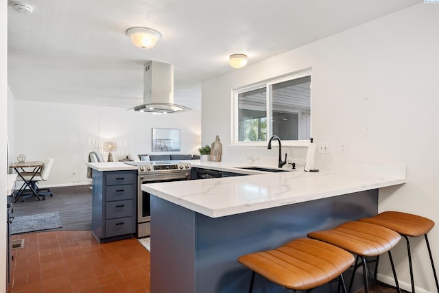 2128 Shasta Ave, Richland, WA 99354 - kitchen with stainless steel electric range oven, exhaust hood, a sink, a peninsula, and brick floor