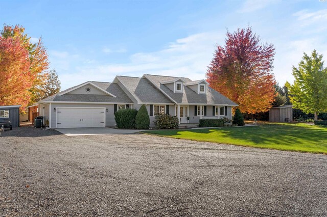 view of front facade featuring a garage, central AC unit, covered porch, and a front lawn