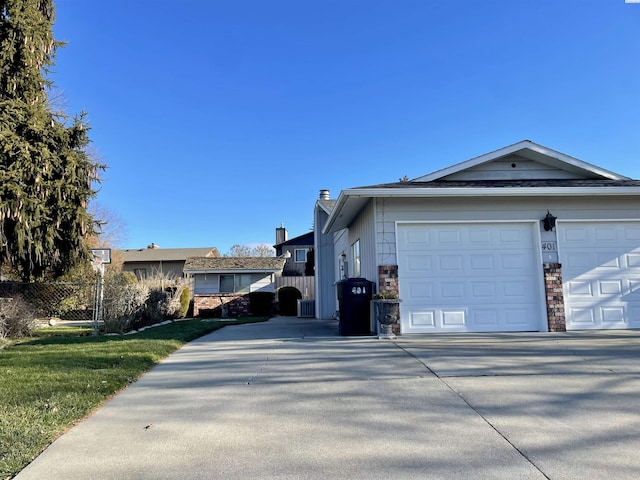 view of home's exterior featuring a garage and a lawn