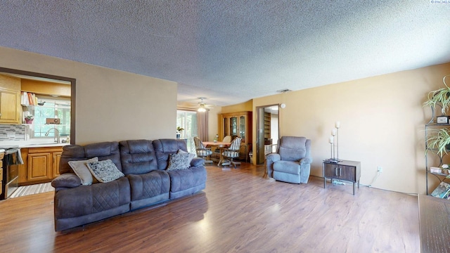 2816 S Cedar St, Kennewick, WA 99337 - living room featuring wood finished floors, a textured ceiling, and ceiling fan