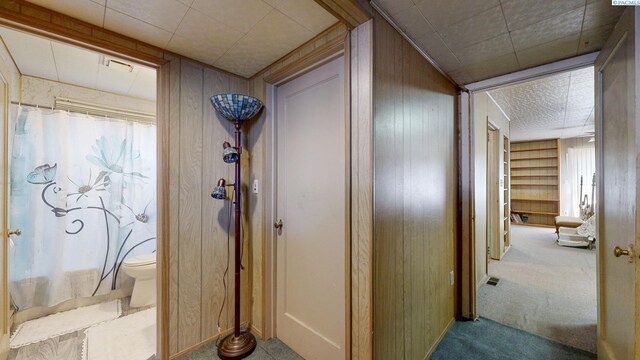 2816 S Cedar St, Kennewick, WA 99337 - corridor with wooden walls, carpet floors, and baseboards