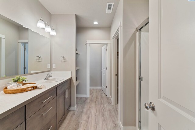 6223 Berea Ln, Pasco, WA 99301 - full bath featuring wood finished floors, vanity, a shower stall, and recessed lighting