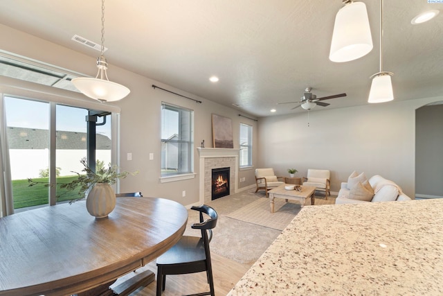 6223 Berea Ln, Pasco, WA 99301 - dining room featuring a lit fireplace, recessed lighting, light wood-style floors, and a ceiling fan