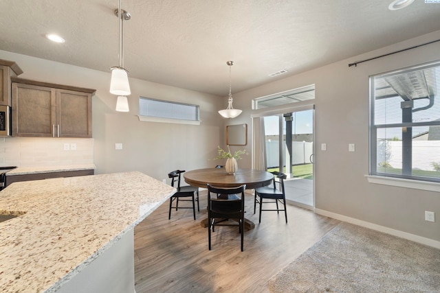 6223 Berea Ln, Pasco, WA 99301 - dining space featuring light wood-style flooring, recessed lighting, and a textured ceiling
