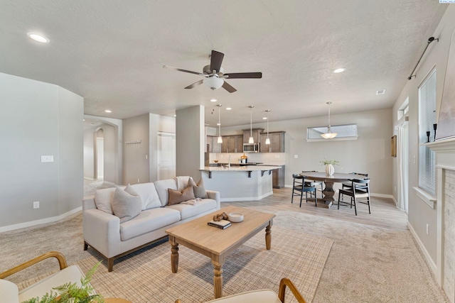 6223 Berea Ln, Pasco, WA 99301 - living area featuring a ceiling fan, light colored carpet, arched walkways, recessed lighting, and a textured ceiling