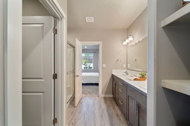 6223 Berea Ln, Pasco, WA 99301 - full bath featuring wood finished floors, double vanity, a shower with shower door, and ensuite bath