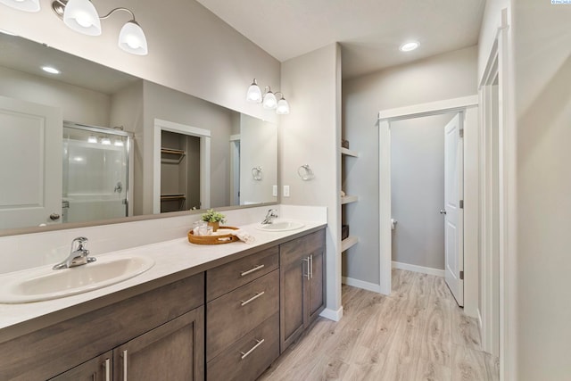 6223 Berea Ln, Pasco, WA 99301 - full bathroom featuring a shower stall, double vanity, a spacious closet, and wood finished floors