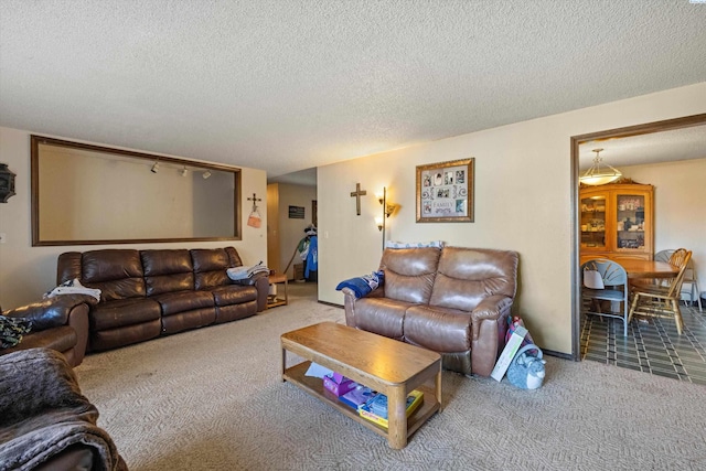 living room with a textured ceiling and carpet