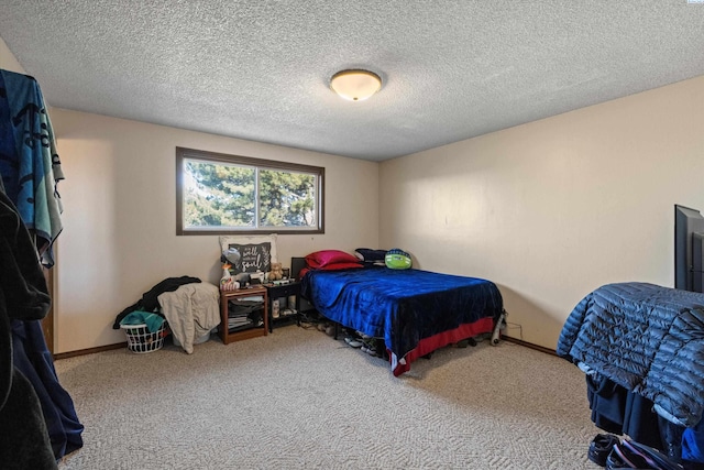 carpeted bedroom featuring a textured ceiling