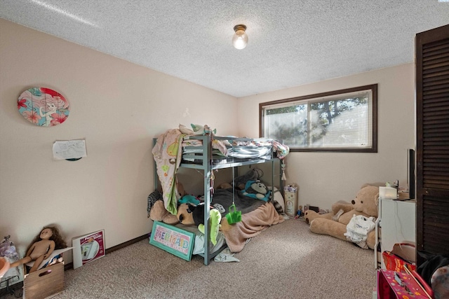 bedroom with a textured ceiling and carpet