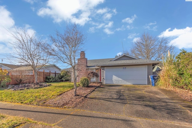 ranch-style home with a garage and a front lawn