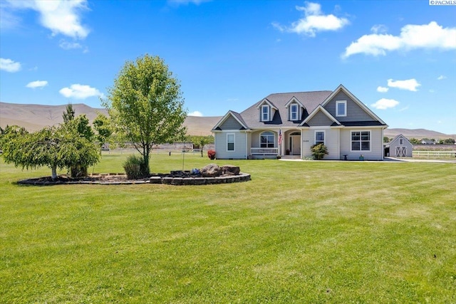 19408 Quail Run Pr SW, Prosser, WA 99350 - view of front of house with a mountain view, a front lawn, and covered porch