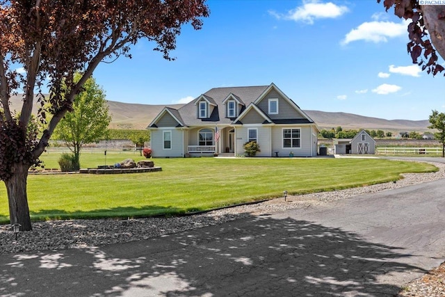 19408 Quail Run Pr SW, Prosser, WA 99350 - view of front of house featuring a mountain view, covered porch, a front yard, and driveway