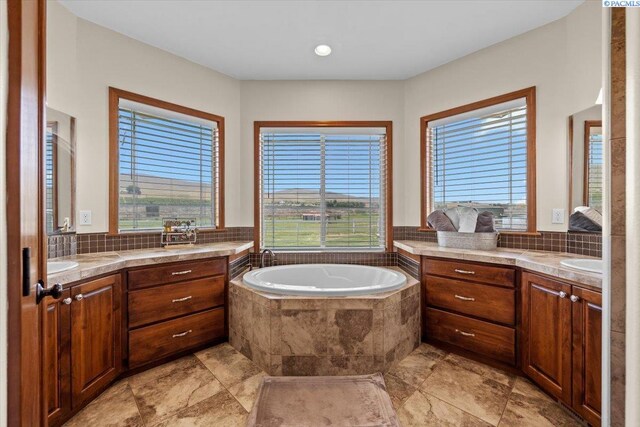 19408 Quail Run Pr SW, Prosser, WA 99350 - full bathroom with a bath, two vanities, and tasteful backsplash