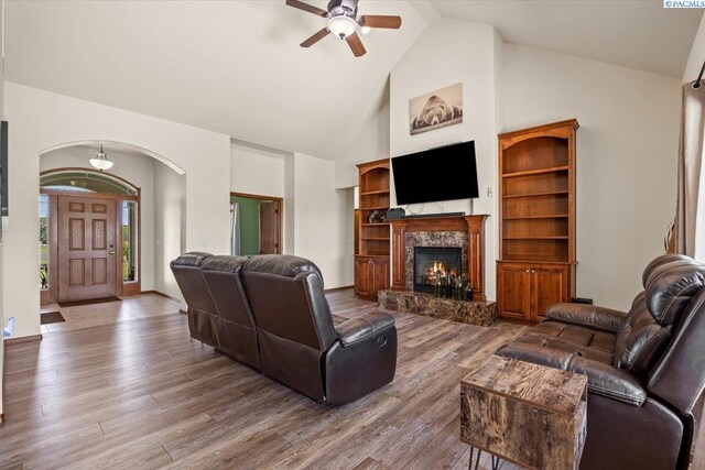 19408 Quail Run Pr SW, Prosser, WA 99350 - living room with high vaulted ceiling, ceiling fan, arched walkways, wood finished floors, and a fireplace