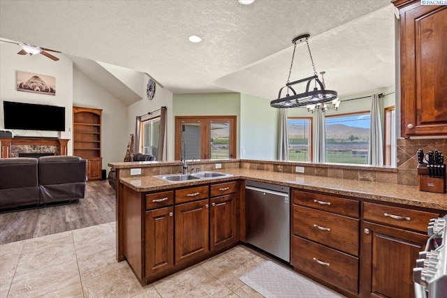 19408 Quail Run Pr SW, Prosser, WA 99350 - kitchen featuring dishwasher, a sink, lofted ceiling, stone counters, and a textured ceiling