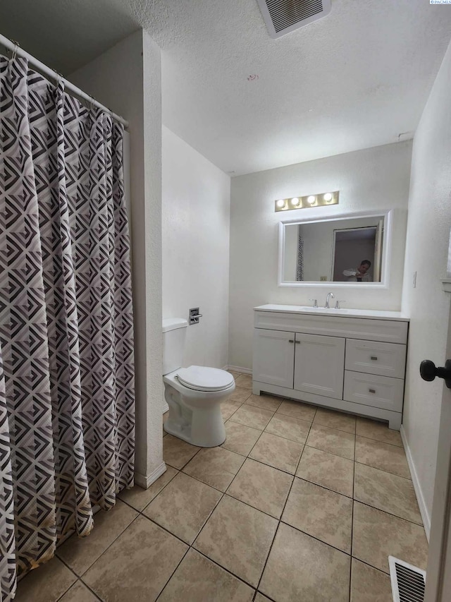 bathroom with visible vents, tile patterned flooring, toilet, and vanity
