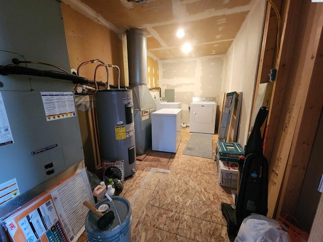 below grade area featuring water heater and washer and dryer