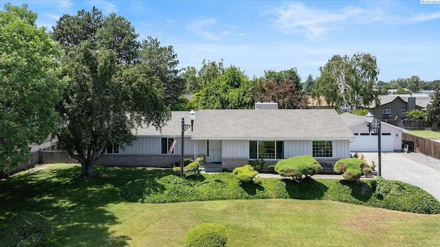 3916 S Date St, Kennewick, WA 99337 - ranch-style home featuring concrete driveway, board and batten siding, roof with shingles, and a chimney