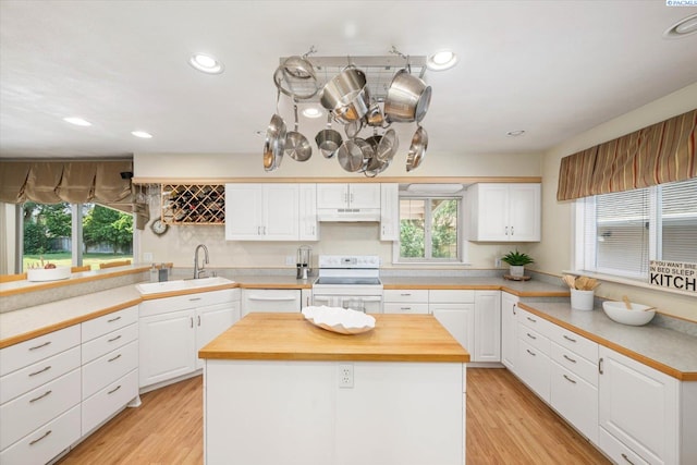 3916 S Date St, Kennewick, WA 99337 - kitchen featuring white appliances, white cabinetry, under cabinet range hood, healthy amount of natural light, and recessed lighting