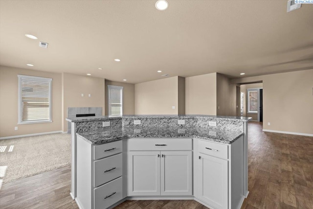 kitchen featuring a kitchen island, wood finished floors, and open floor plan