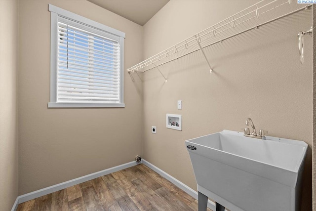 washroom featuring laundry area, wood finished floors, hookup for a washing machine, a sink, and hookup for an electric dryer