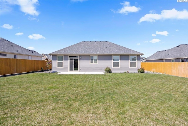 rear view of house featuring a fenced backyard, a yard, and a patio area