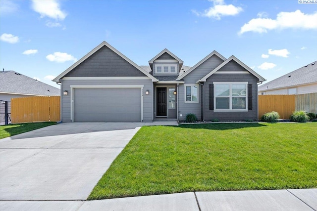 craftsman house featuring a garage, a front lawn, fence, and concrete driveway