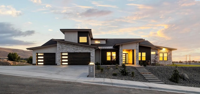 contemporary home featuring a garage and a mountain view