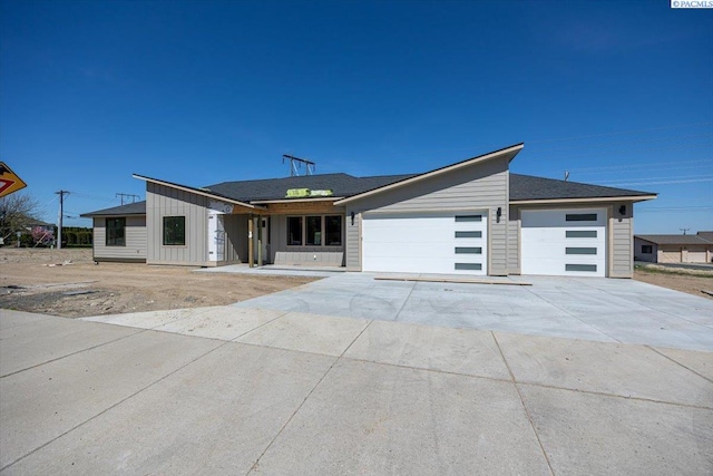 4218 W 19th Ave, Kennewick, WA 99337 - view of front of home with an attached garage, board and batten siding, and driveway
