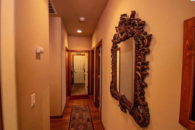 corridor featuring visible vents, dark wood-type flooring, and recessed lighting