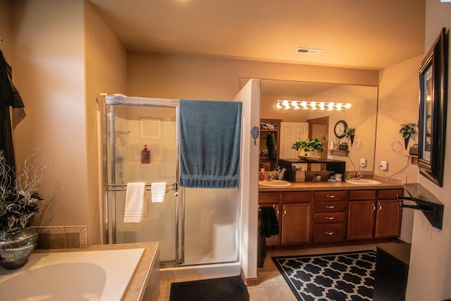 bathroom featuring a garden tub, tile patterned floors, a sink, and a shower stall