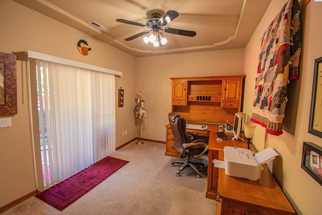 office area with ceiling fan, visible vents, baseboards, and light colored carpet