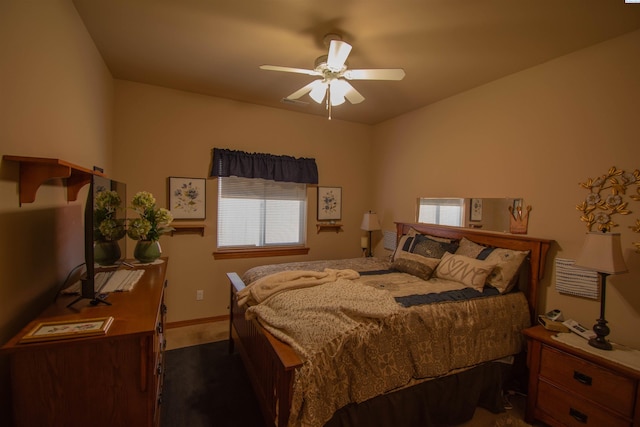 bedroom with ceiling fan and baseboards