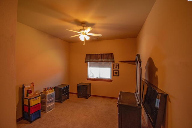 misc room with a ceiling fan, visible vents, light carpet, and baseboards