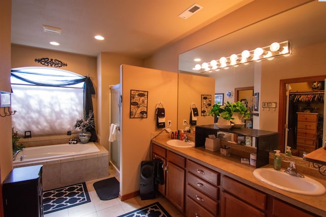 bathroom with visible vents, a sink, a bath, and double vanity