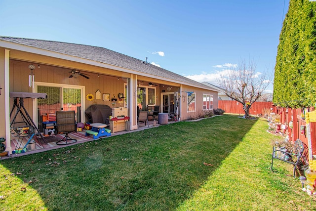 exterior space featuring ceiling fan, a patio, a lawn, and a fenced backyard