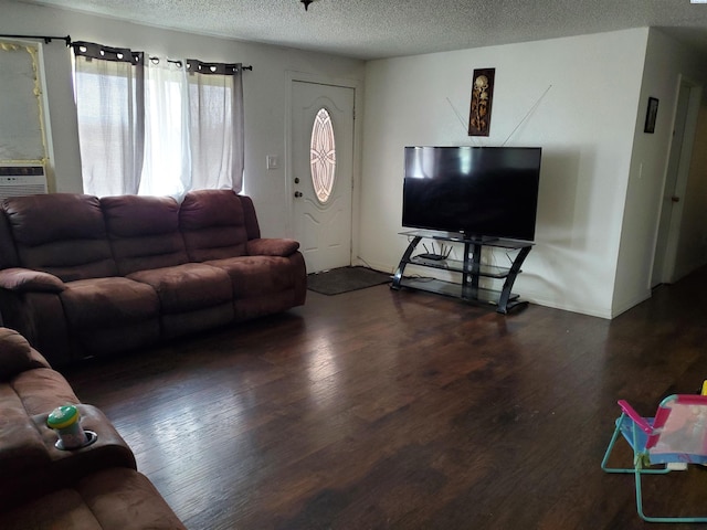 living room featuring dark wood-type flooring and a textured ceiling