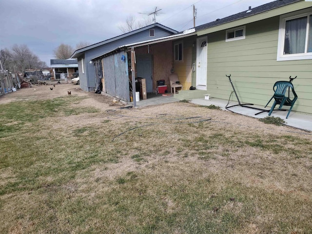 rear view of property with a yard