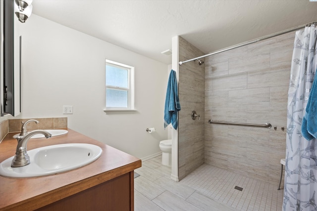 5168 Chris St, West Richland, WA 99353 - bathroom with double vanity, toilet, and a tile shower