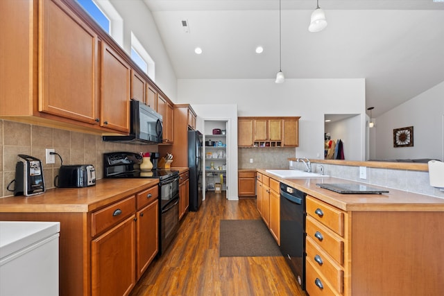 5168 Chris St, West Richland, WA 99353 - kitchen with black appliances, a sink, dark wood-style flooring, brown cabinetry, and light countertops