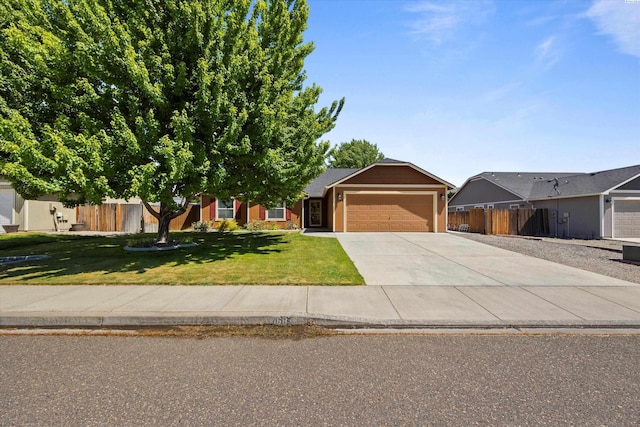5168 Chris St, West Richland, WA 99353 - view of front of home featuring an attached garage and driveway