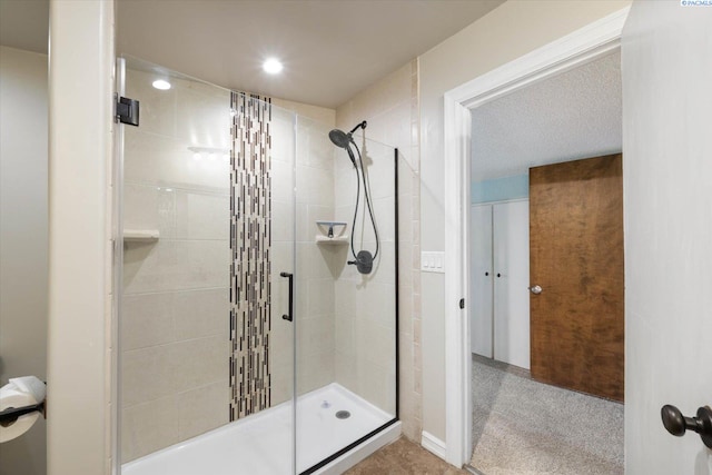 bathroom featuring recessed lighting and a shower stall