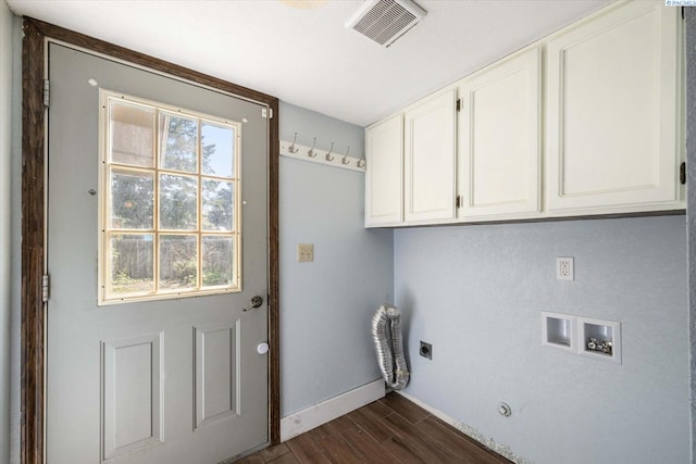 clothes washing area with electric dryer hookup, visible vents, cabinet space, baseboards, and dark wood-style floors